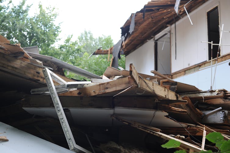 The partially demolished wooden frame of a building.