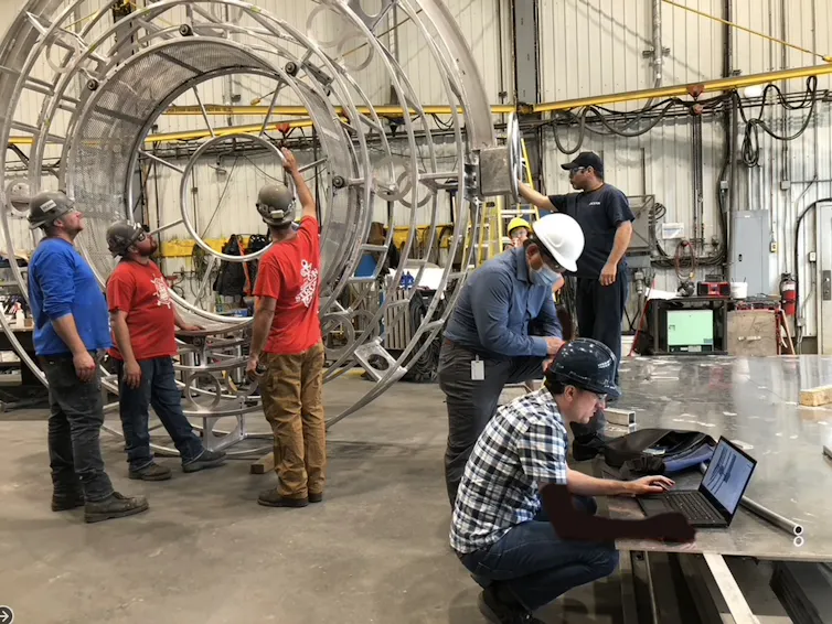 people working on the design of a wheel