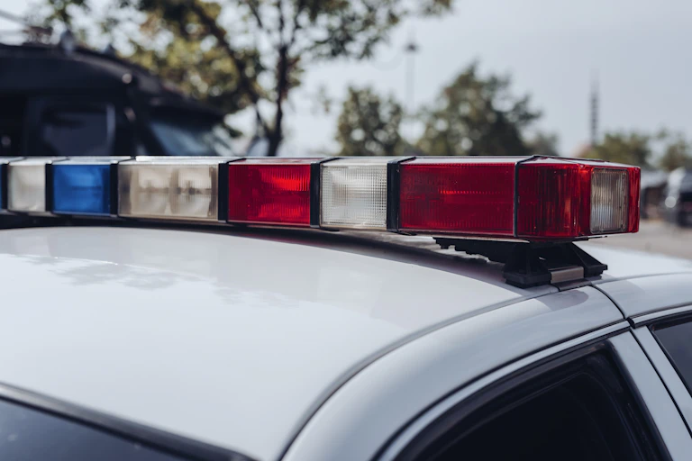 Blue and red emergency lights sit atop a police vehicle.