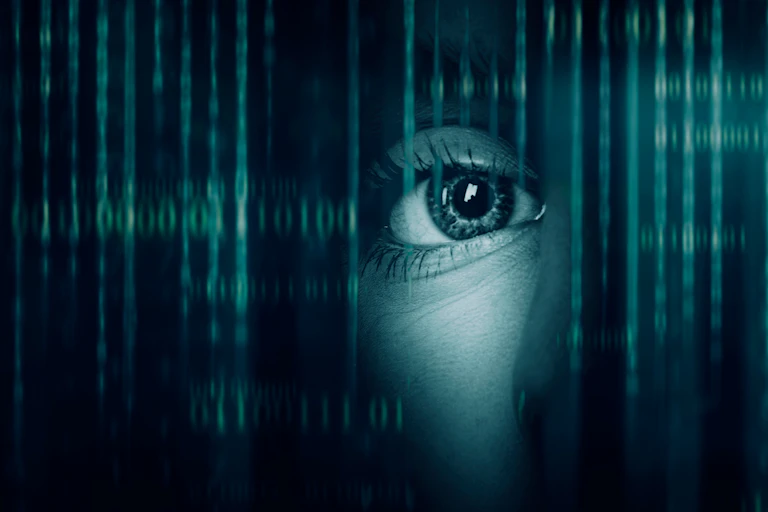 a woman peers from behind a digital "curtain"