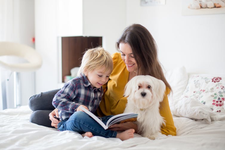 A mother, daughter and dog.