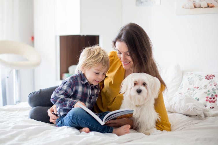 A mother, daughter and dog.