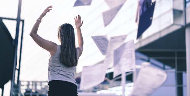 Woman throwing papers into the air