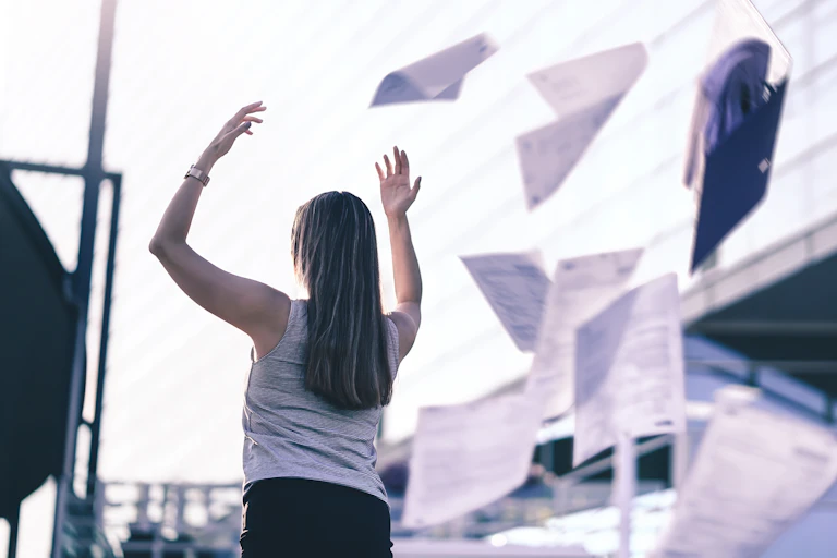 Woman throwing papers into the air
