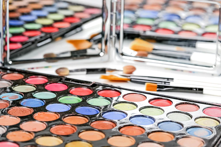 Trays of makeup in front of a mirror