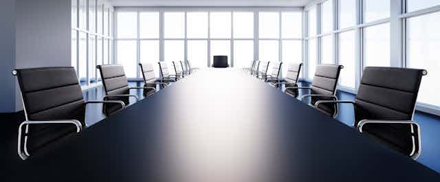 A black-and-white photo of an empty boardroom.