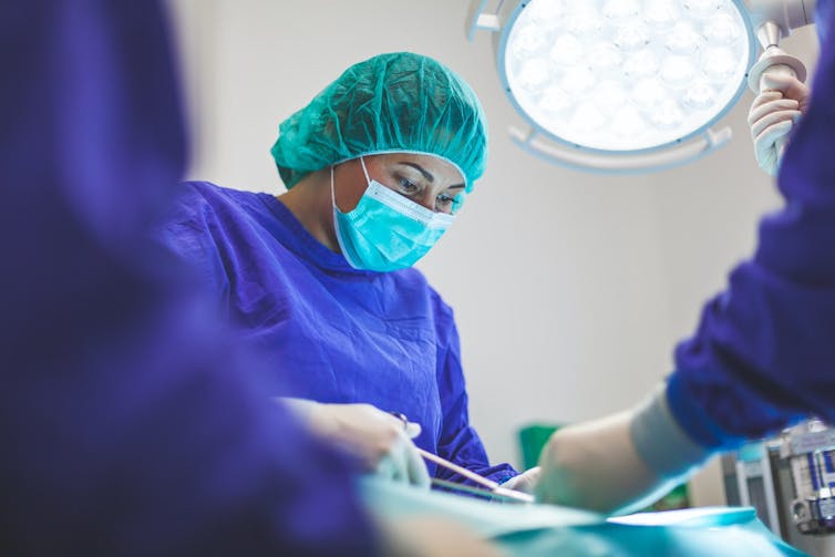 Female surgeon operating