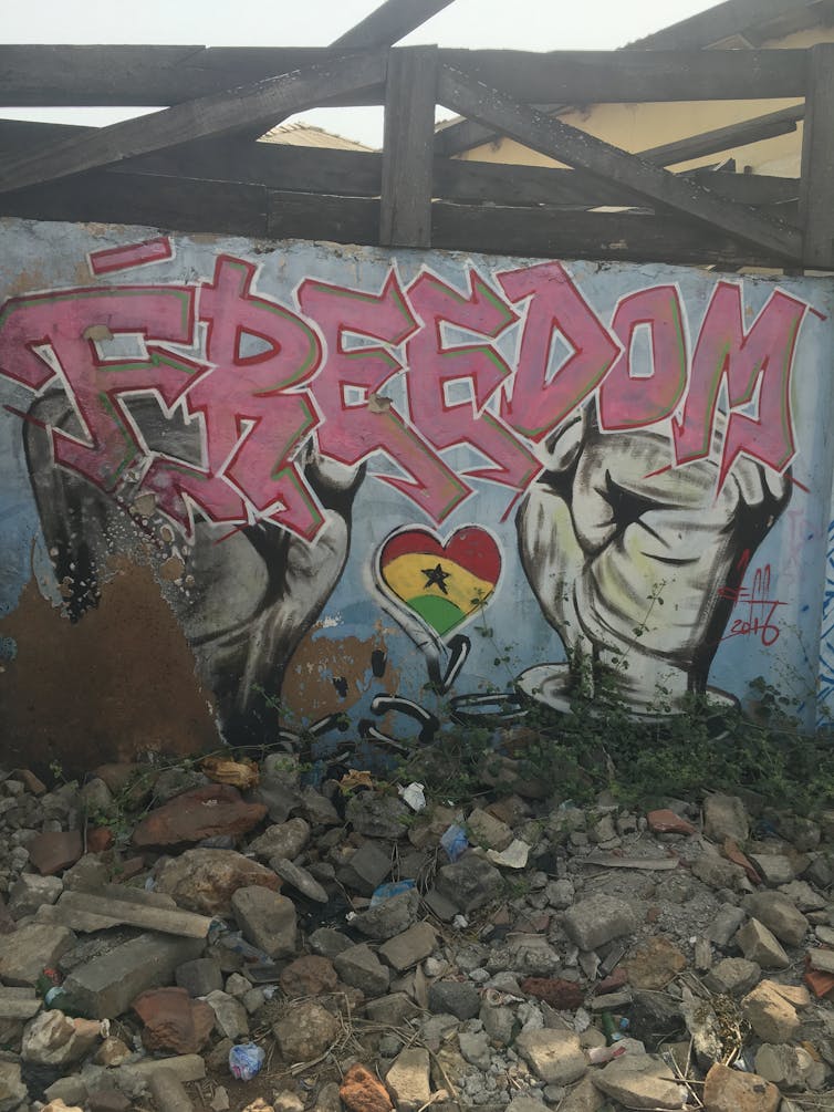 A piece of graffiti showing a pair hands in chains breaking the chains with the word 'Freedom' above.