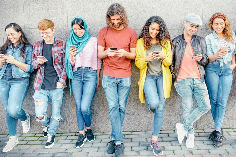 Line of younger people on smartphones