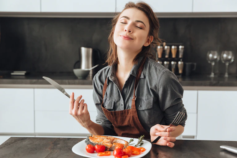 Woman closes her eyes as she eats