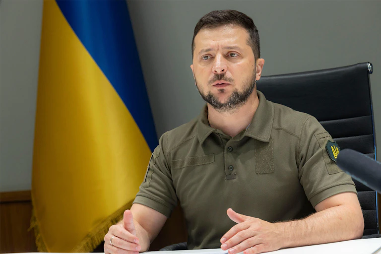 Ukrainian president, Volodymyr Zelensky, makes a statement in front o fthe Ukrainian flag.