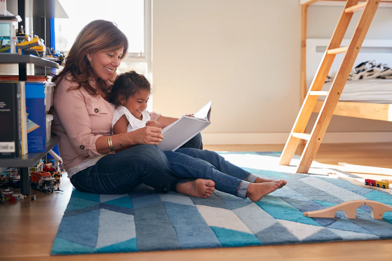 A grandma is seen reading with her granddaughter.