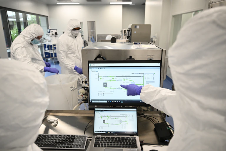 scientists in lab in protective gear