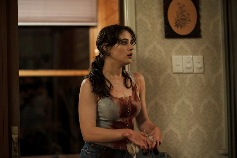 A young white woman in a blood-soaked singlet
