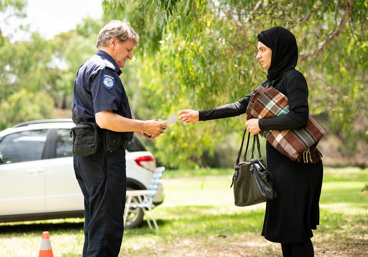 A white male cop and a muslim woman.