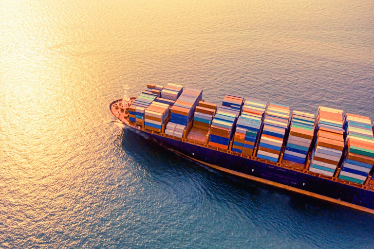 Cargo ship sailing, sunset
