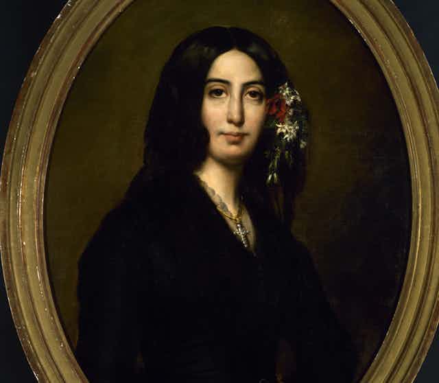 Retrato de una mujer con flores en el pelo.