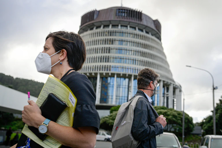 People wearing masks outside NZ's parliament.
