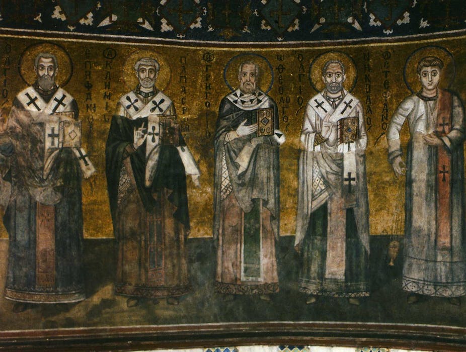 A dark and gold mosaic shows five men in robes with halos around their heads.