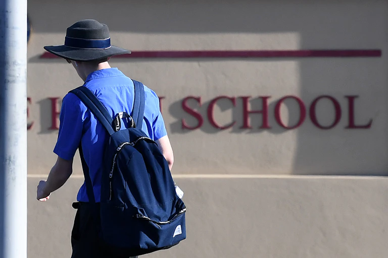 High school student outside school.