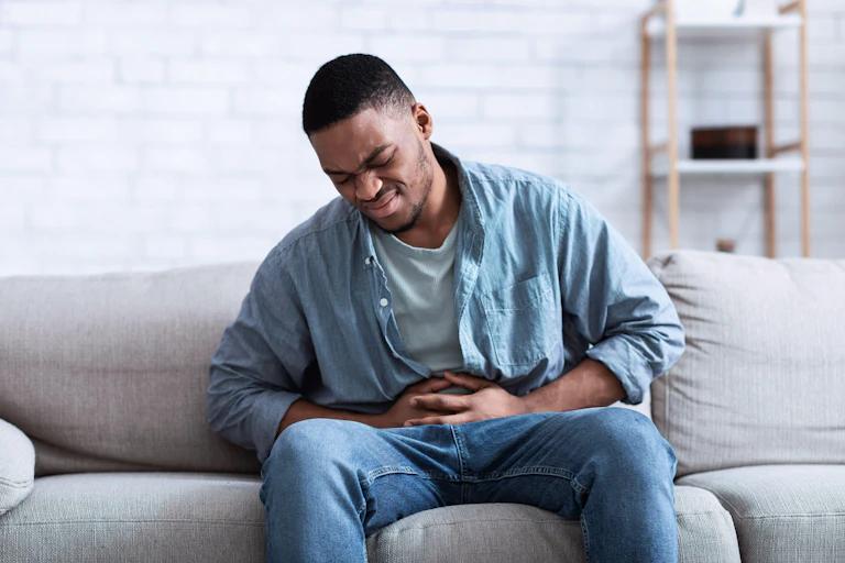 Man holding his stomach in pain