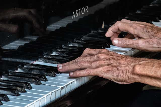 Old hands play an old piano