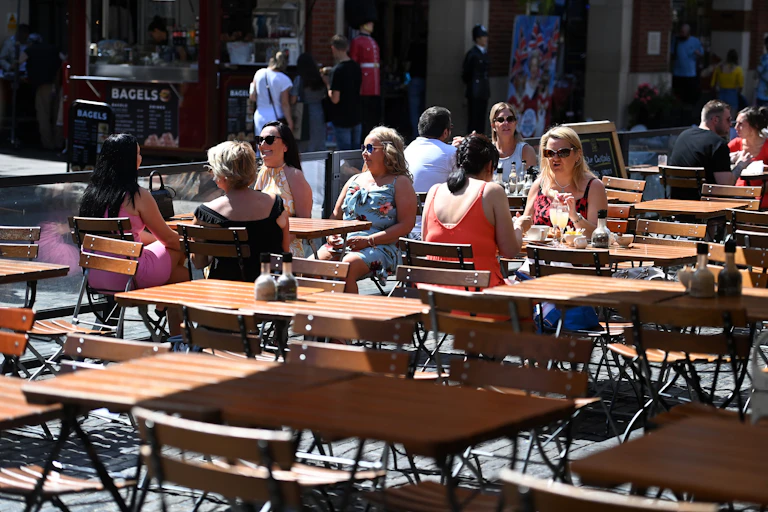 People dining outdoors in London.