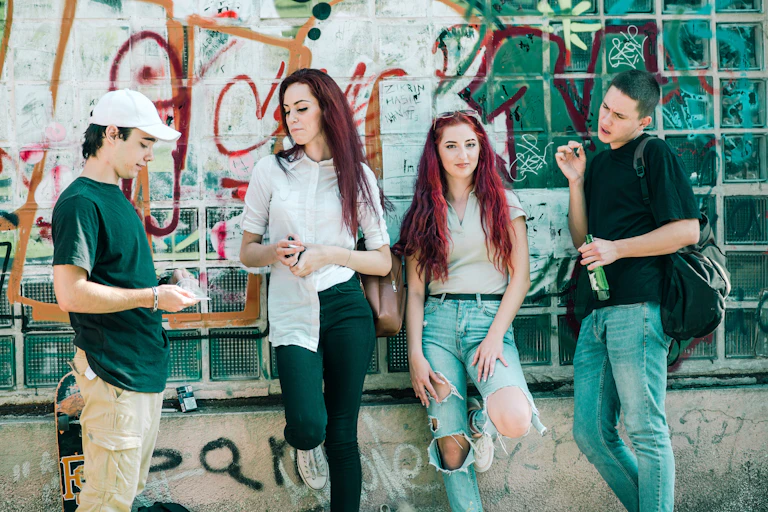 Young people standing against a wall