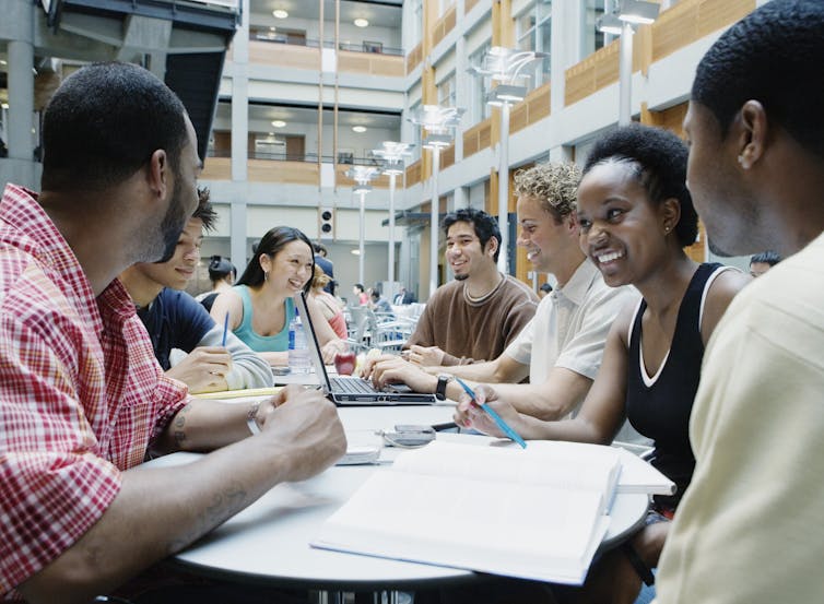 Seven diverse college students studying together