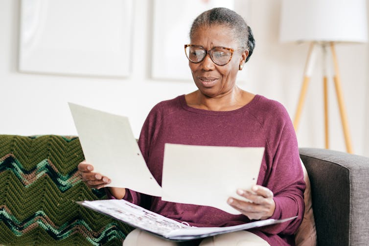 Older woman reading documents at home