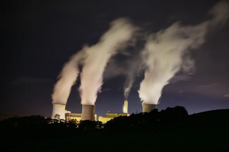three chimneys at coal plant billow steam