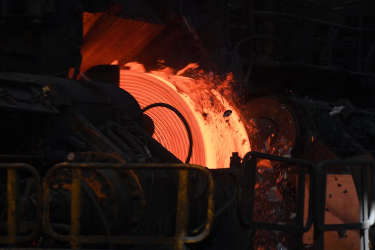 red-hot roll of metal at steelworks