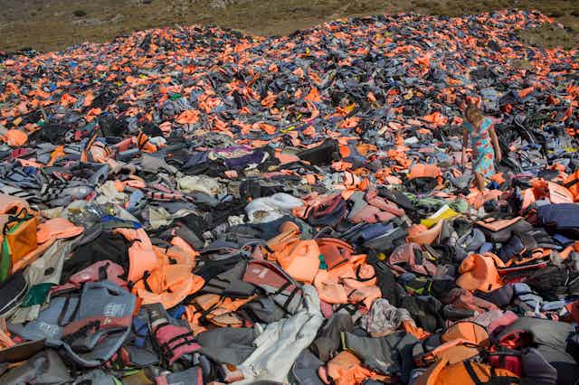 A piece of ground strewn with discarded lifejackets from refugees.