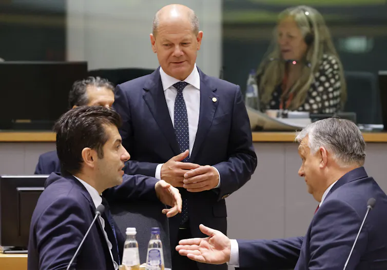 Three men speak at the EU parliament
