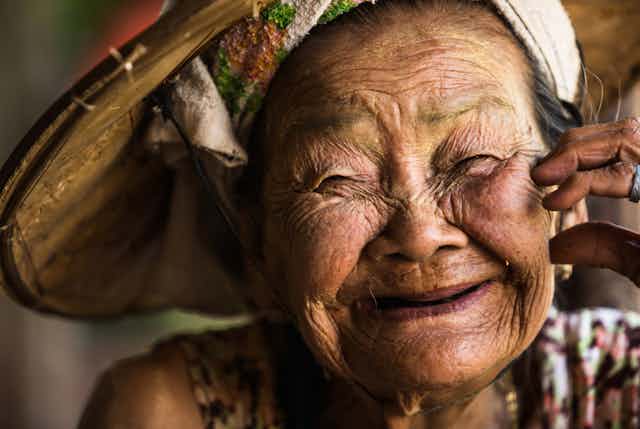 An unidentified, very elderly Asian woman stares with a narrow gaze and a charming face in Phop Phra, Tak, Thailand.