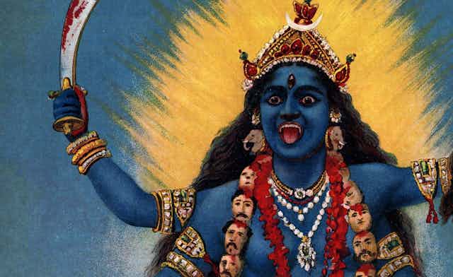 A painting of the goddess Kali. She appears in blue wearing a garland of heads and carrying a severed head in one of her four arms. In another arm she carried a bloodied sword. 
