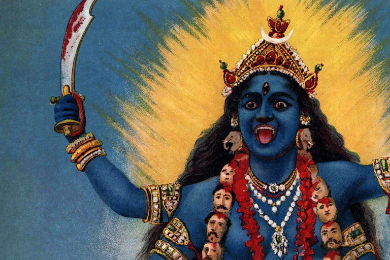 A painting of the goddess Kali. She appears in blue wearing a garland of heads and carrying a severed head in one of her four arms. In another arm she carried a bloodied sword.