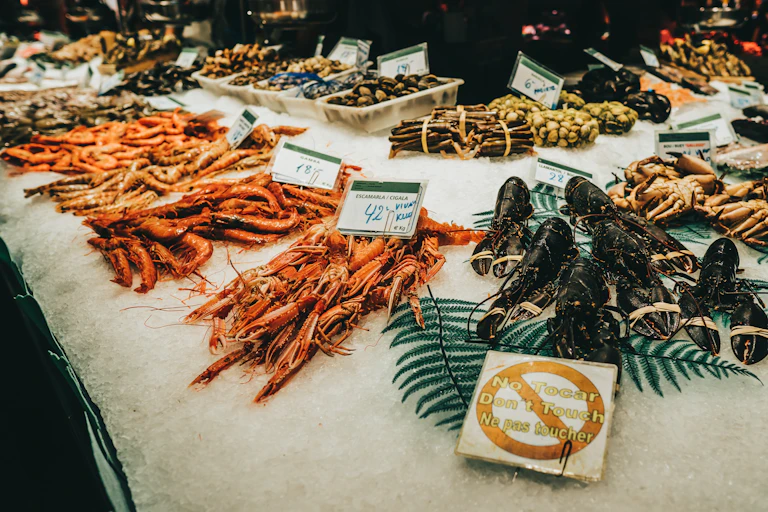 Lobsters sit on an ice bed in a seafood market.