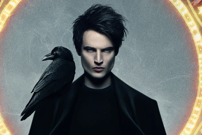 Man in all black with a raven on his shoulder.