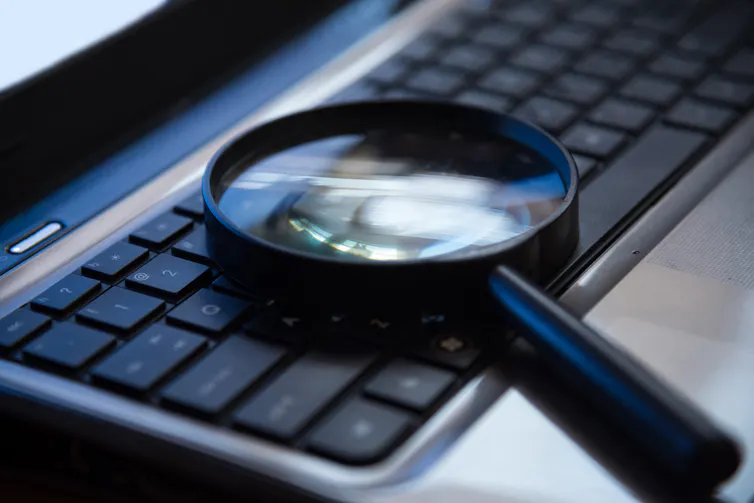 A magnifying glass on a laptop