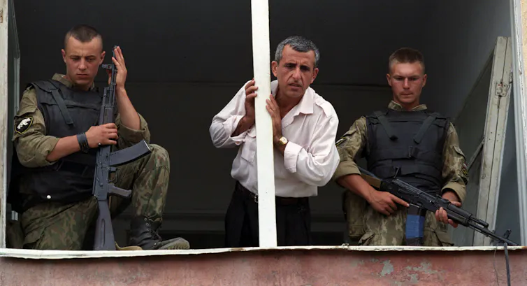 A man speaks with his relative, while he is kept in so-called ‘filtration camp’ for Chechens, detained with arms, or suspected in other illegal actions, Grozny, Chechnya, Russia, 07 September 1995