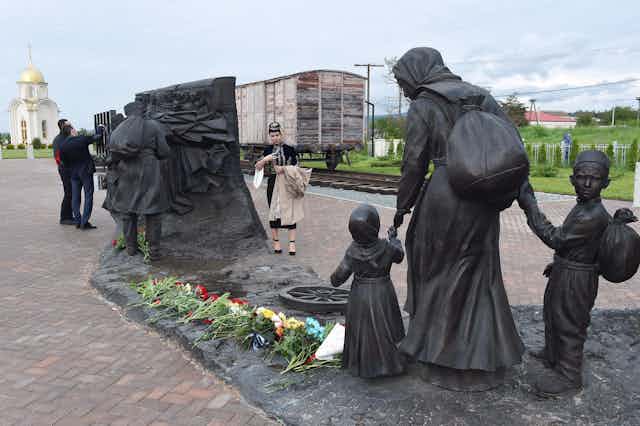 Monument showing a woman and two children being deported from Crimea in the 1940s.