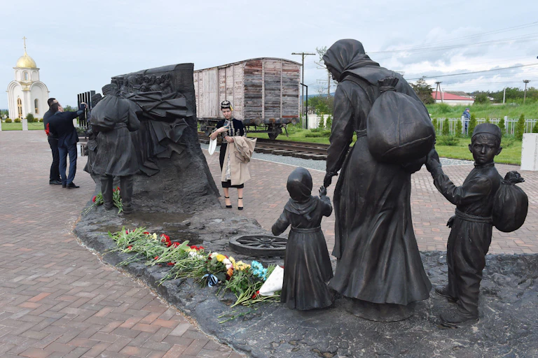 Monument showing a woman and two children being deported from Crimea in the 1940s.