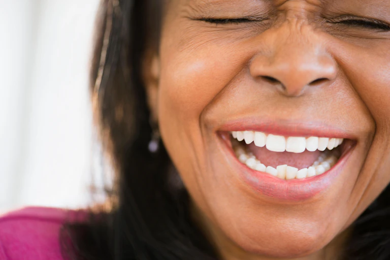 A close of a laughing woman's face.