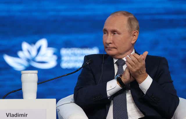 Vladimir Putin applauds a speaker at a  session of the 2022 Eastern Economic Forum.