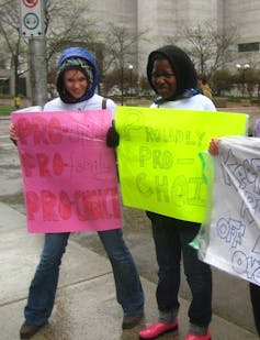 Two young women hold pro-abortion signs at a protest
