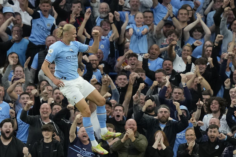 Erling Halland celebrates in front of cheering fans.