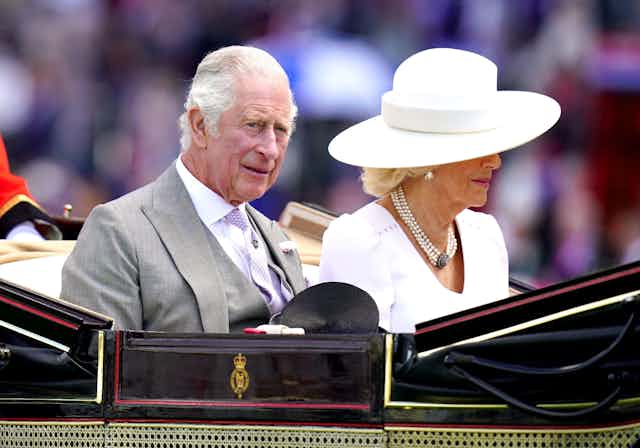Charles and Camilla riding in a carriage.