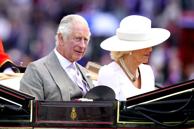 Charles and Camilla riding in a carriage.