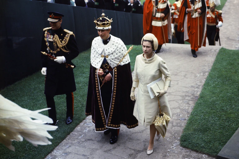 Investiture Ceremony of the Prince of Wales at Caernarfon Castle. Her Majesty Queen Elizabeth II and her son Prince Charles walk towards Queen Eleanor's Gate during the procession.